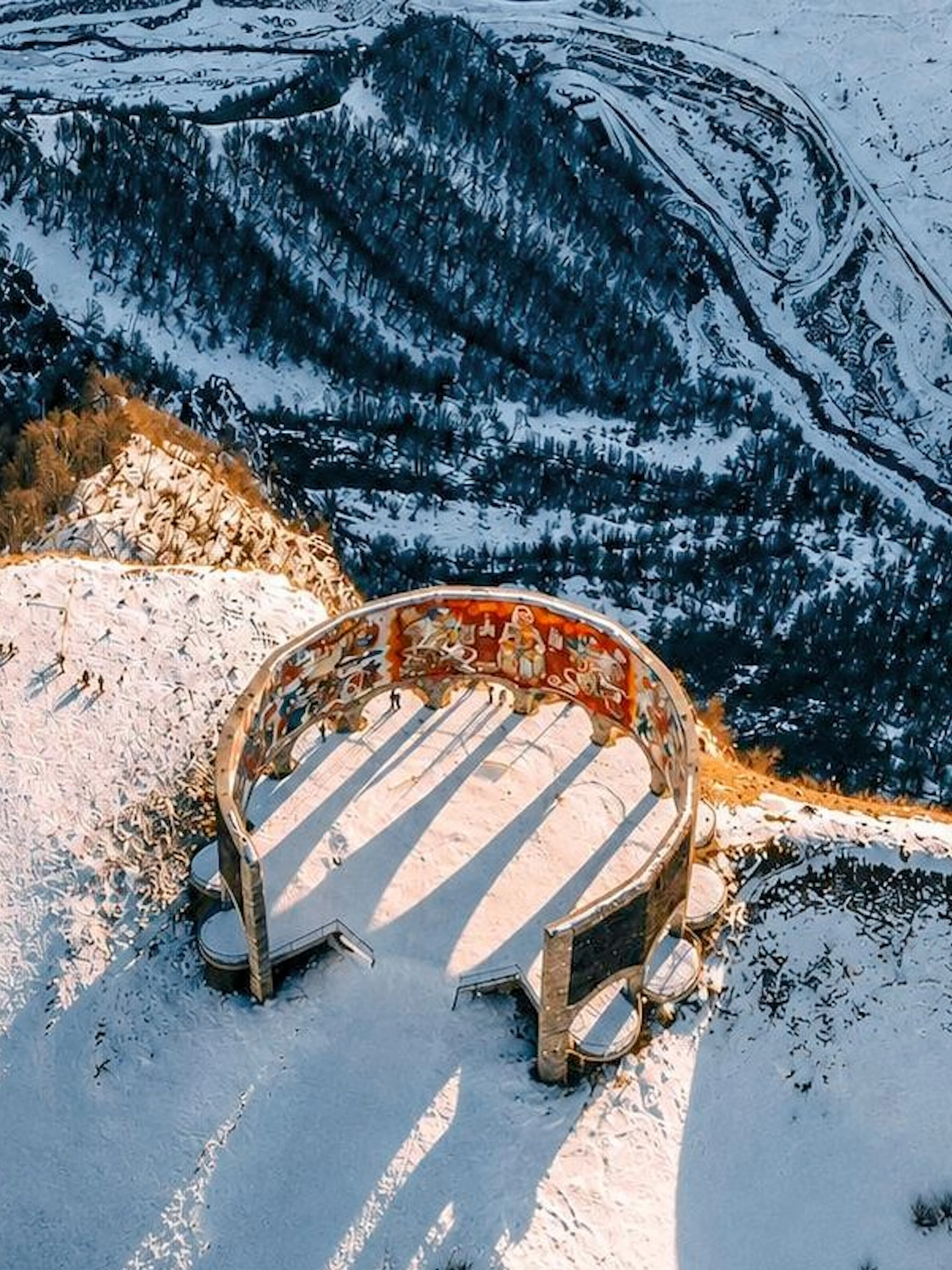 Gudauri View Point in snowy Caucasus Mountains, Georgia, with circular monument.