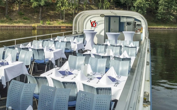 Dinner tables set on a Berlin river cruise boat, ready for a Capital Dinner Cruise.