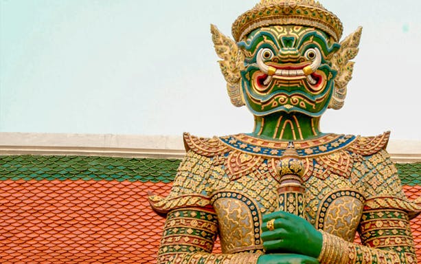 Giant guardian statue at Bangkok's Grand Palace during a half-day guided tour.