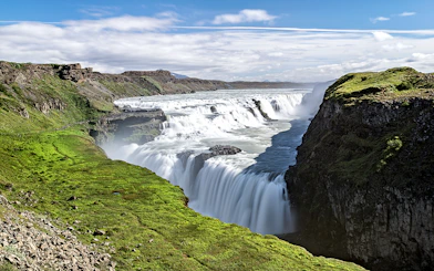 Gullfoss waterfall cascading over rocky cliffs in Iceland.