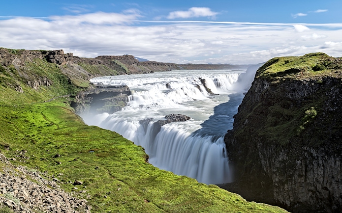 Gullfoss waterfall cascading over rocky cliffs in Iceland.