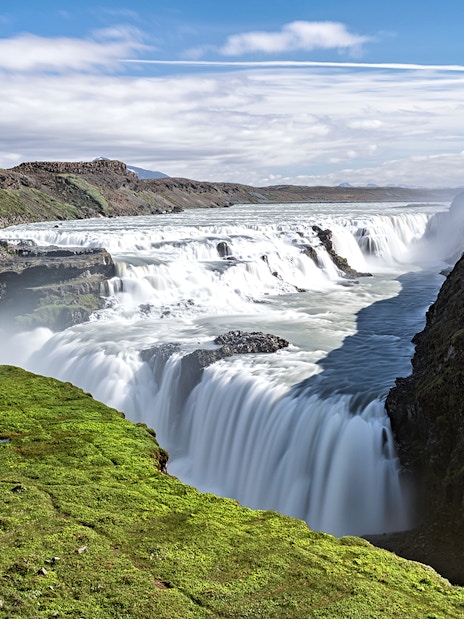 Gullfoss waterfall cascading over rocky cliffs in Iceland.