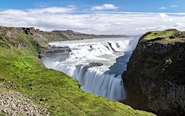 Gullfoss waterfall cascading over rocky cliffs in Iceland.