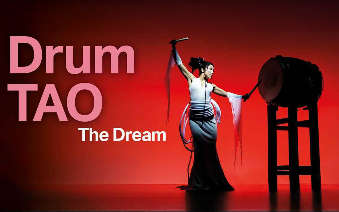 Performer playing traditional drum in Drum Tao show.