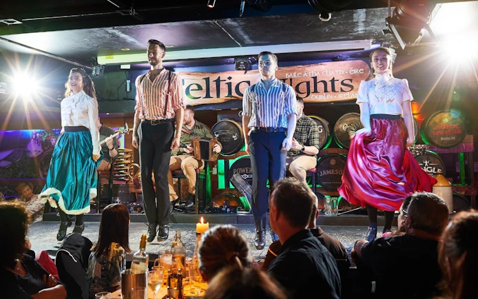 Dancers performing traditional Irish dance at Celtic Nights show in Dublin.
