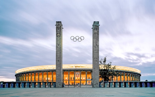 Exterior view of Olympiastadion Berlin with Olympic rings.