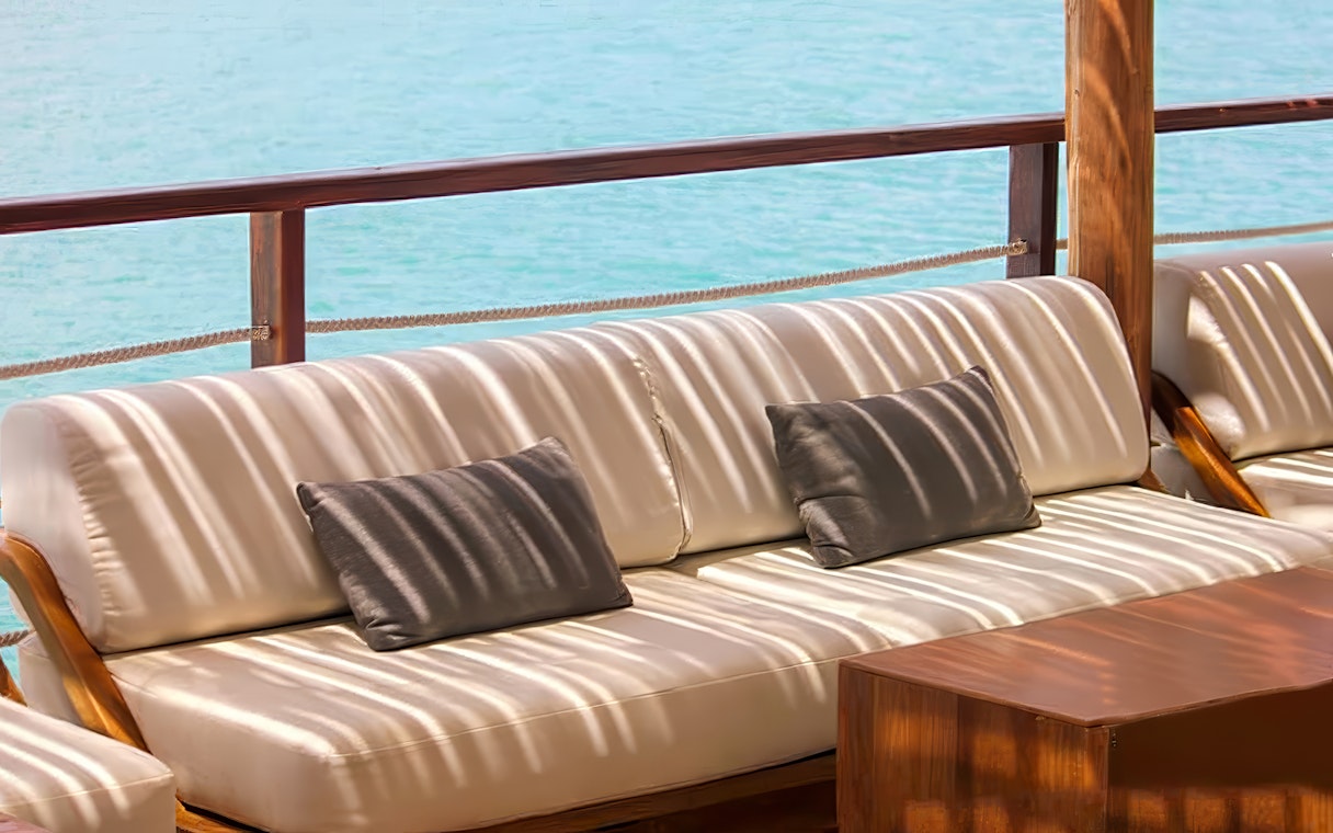 Outdoor seating area at Yona Beach Club, Phuket, overlooking the ocean.