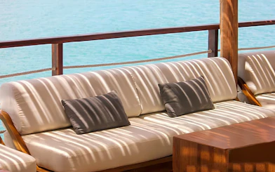 Outdoor seating area at Yona Beach Club, Phuket, overlooking the ocean.