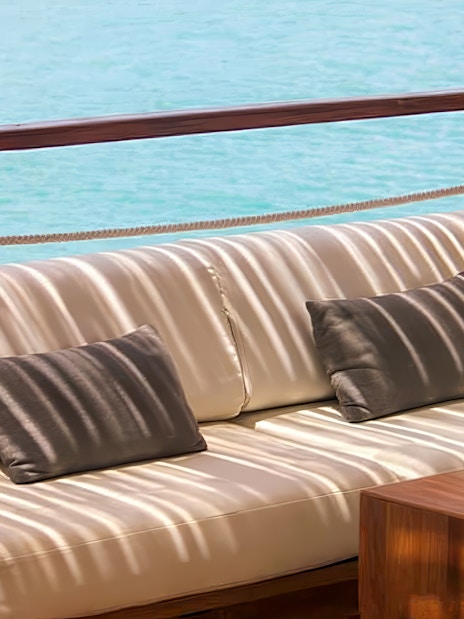 Outdoor seating area at Yona Beach Club, Phuket, overlooking the ocean.