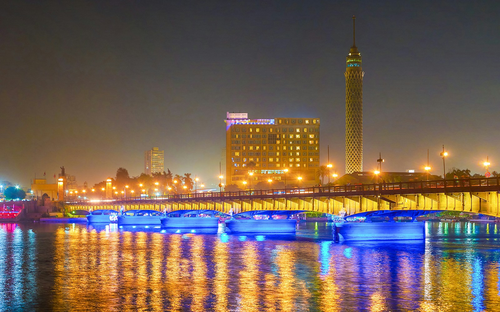 Cairo Tower and bridge illuminated at night, Cairo, Egypt.