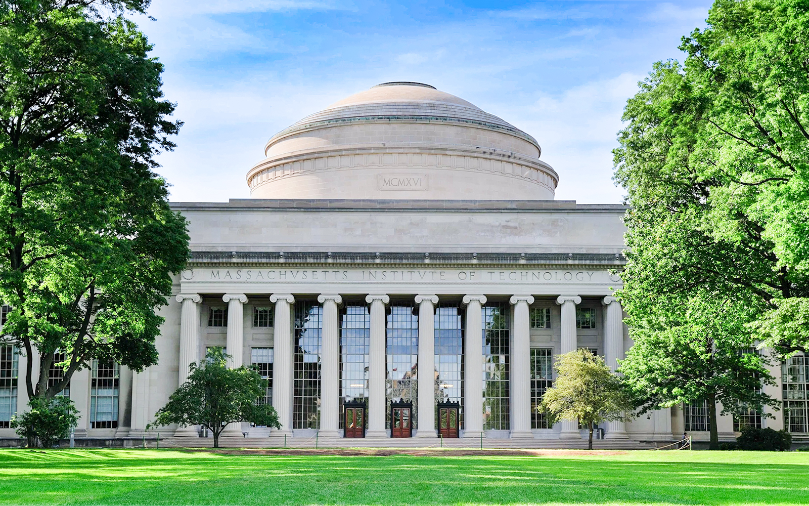 MIT Dome with columns in Cambridge, Massachusetts, surrounded by trees.