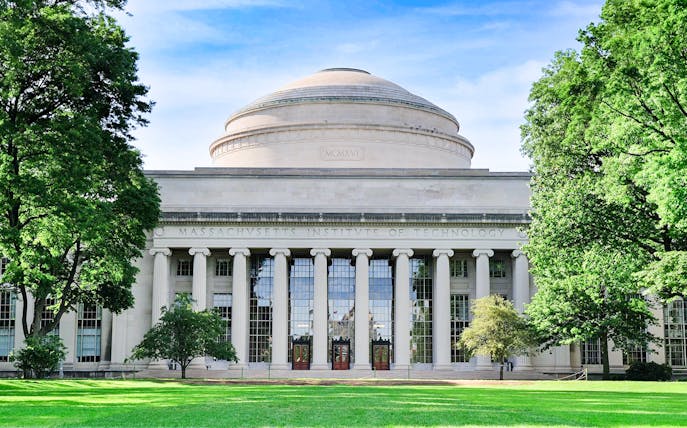 MIT Dome with columns in Cambridge, Massachusetts, surrounded by trees.