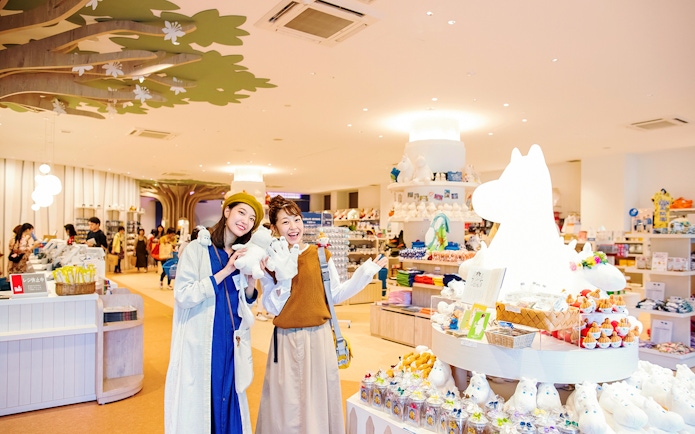 Visitors enjoying Moominvalley Park gift shop with Moomin merchandise.