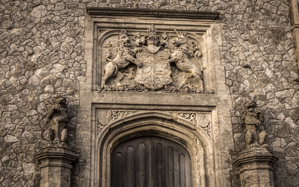 Dover Castle stone doorway with intricate coat of arms and lion sculptures.