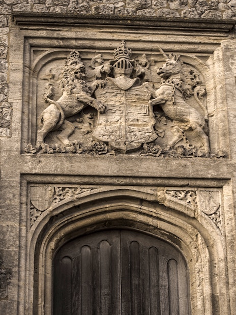 Dover Castle stone doorway with intricate coat of arms and lion sculptures.
