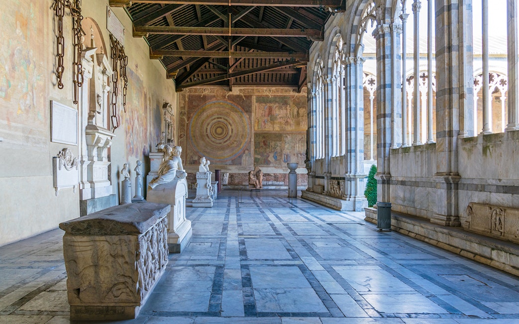 Pisa Camposanto interior with sculptures and frescoes, located in Pisa Cathedral Square.