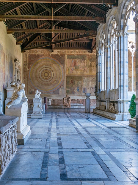 Pisa Camposanto interior with sculptures and frescoes, located in Pisa Cathedral Square.