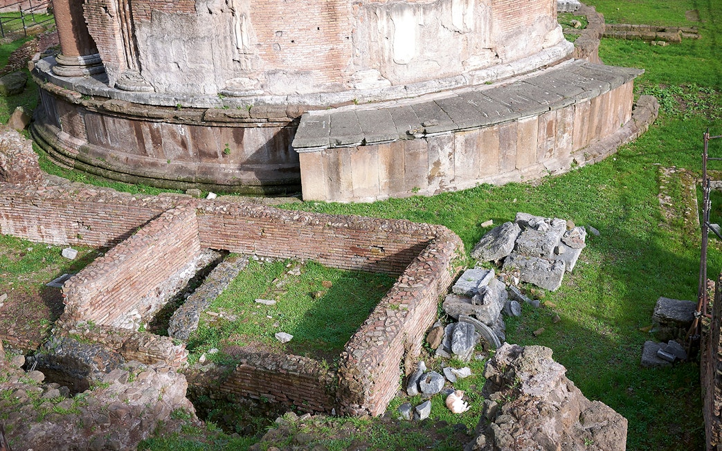 Largo di Torre Argentina ruins in Rome, featuring ancient brick walls and stone structures.