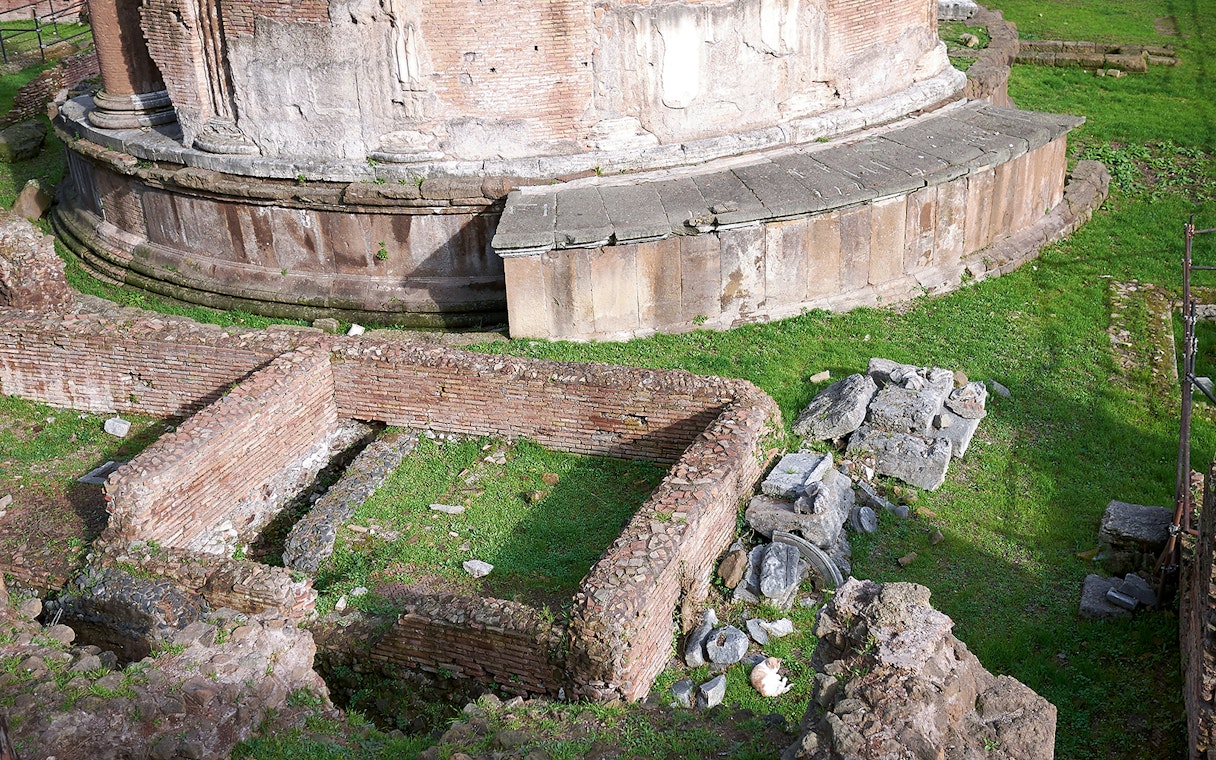 Largo di Torre Argentina ruins in Rome, featuring ancient brick walls and stone structures.