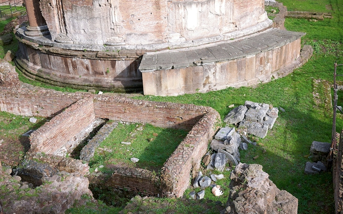 Largo di Torre Argentina ruins in Rome, featuring ancient brick walls and stone structures.