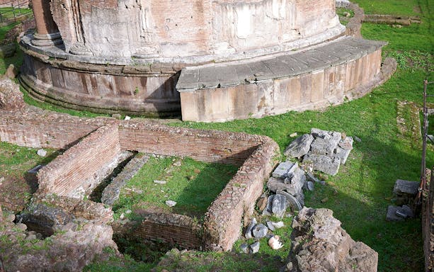 Largo di Torre Argentina ruins in Rome, featuring ancient brick walls and stone structures.