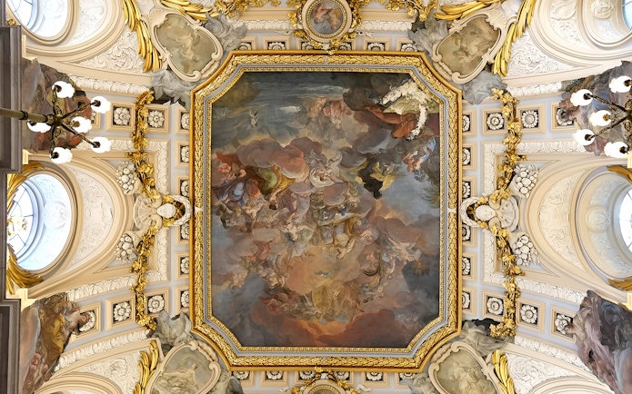 Ceiling fresco and ornate details in the Royal Palace of Madrid during a guided tour.