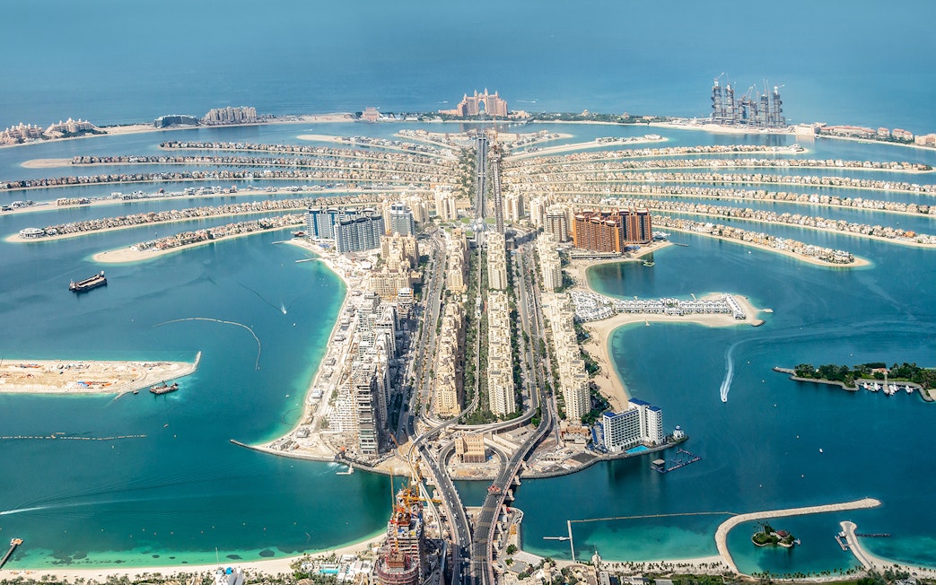 Aerial view of Palm Jumeirah in Dubai with Atlantis Hotel in the distance.