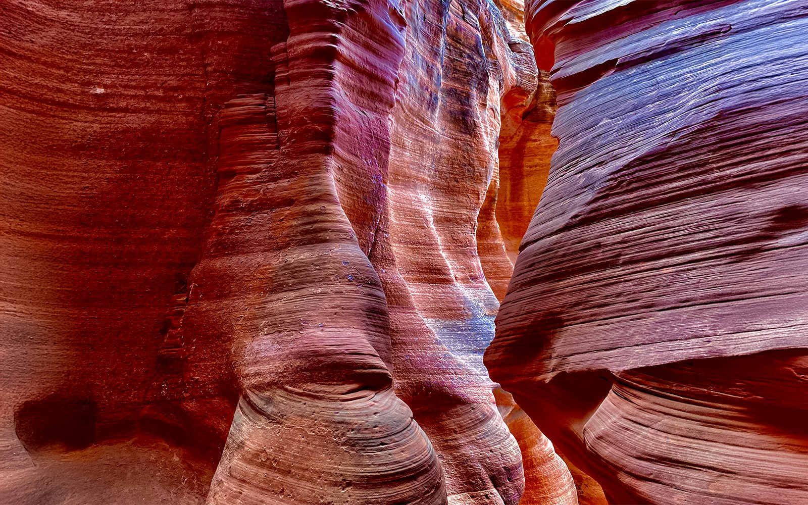 Antelope Canyon X sandstone formations with vibrant colors and light patterns.