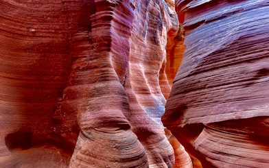 Antelope Canyon X sandstone formations with vibrant colors and light patterns.