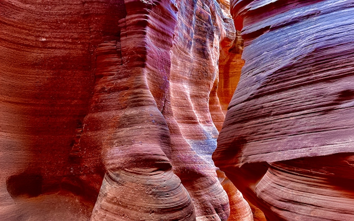 Antelope Canyon X sandstone formations with vibrant colors and light patterns.