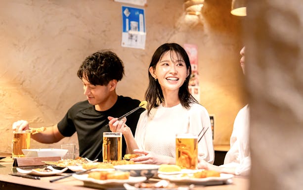 Dining experience in Asakusa with friends enjoying food and drinks, part of Senso-ji Temple audio tour.