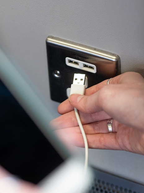USB charging port on Heathrow Express train at London Paddington Station.