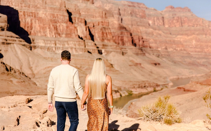 Guests walking at Grand Canyon West Rim during helicopter tour floor landing.