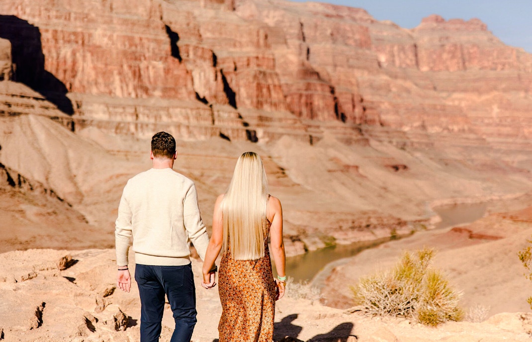 Guests walking at Grand Canyon West Rim during helicopter tour floor landing.