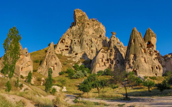 Uçhisar Castle with surrounding fairy chimneys in Cappadocia, Turkey.