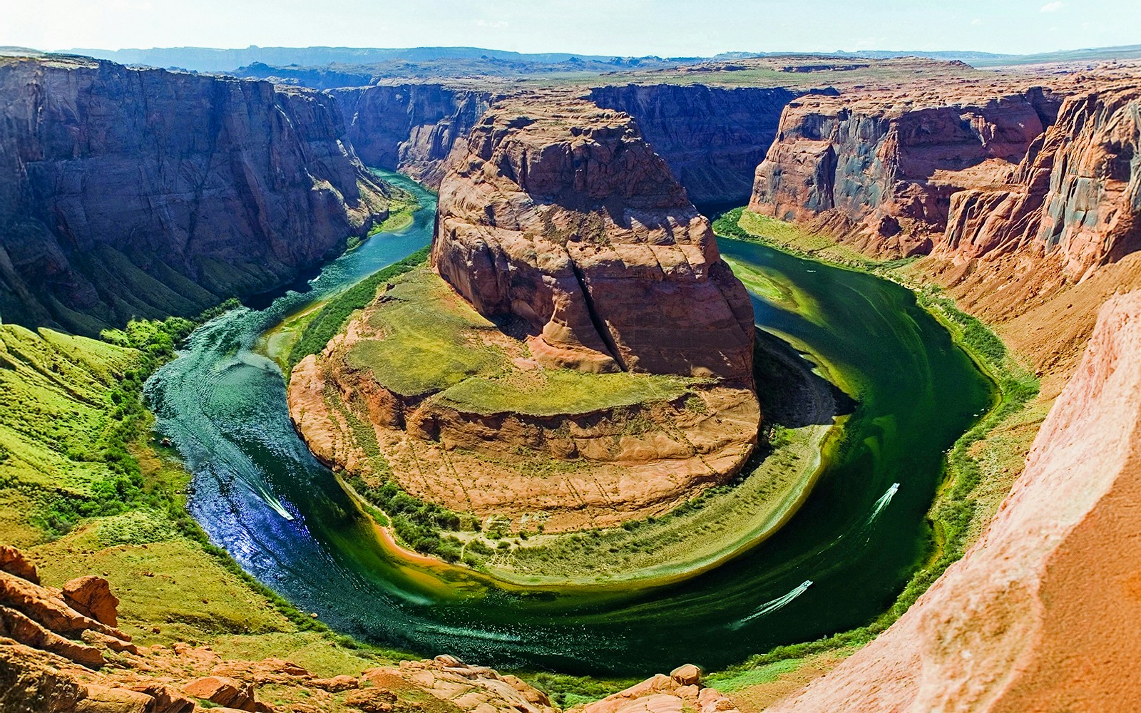 Aerial view of Horseshoe Bend with Colorado River, part of a helicopter tour experience.
