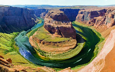 Aerial view of Horseshoe Bend with Colorado River, part of a helicopter tour experience.