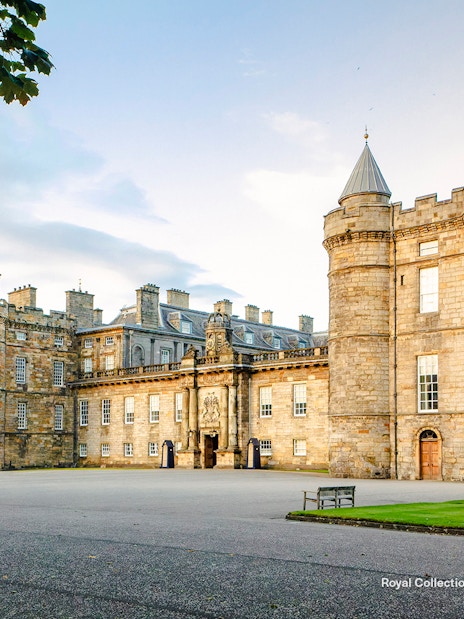 Palace of Holyroodhouse exterior with stone towers and courtyard in Edinburgh, Scotland.