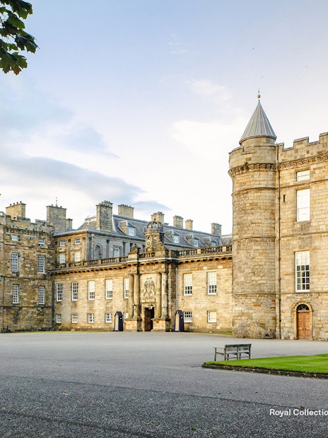 Palace of Holyroodhouse exterior with stone towers and courtyard in Edinburgh, Scotland.
