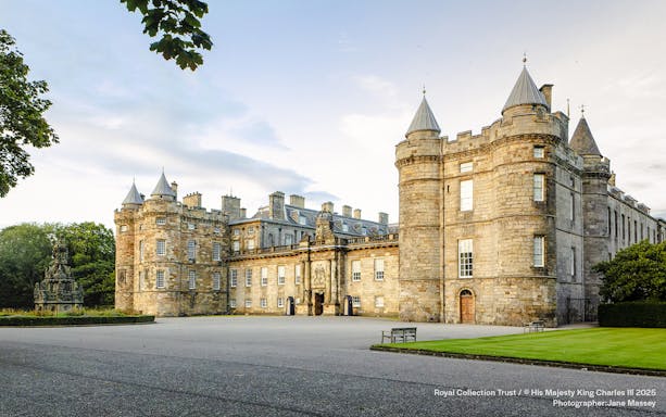 Palace of Holyroodhouse exterior with stone towers and courtyard in Edinburgh, Scotland.