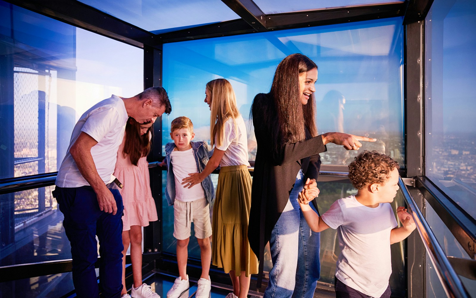 Visitors enjoying the view from Melbourne Skydeck's glass observation deck.