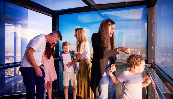 Visitors enjoying the view from Melbourne Skydeck's glass observation deck.