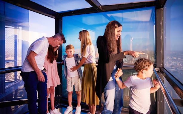 Visitors enjoying the view from Melbourne Skydeck's glass observation deck.