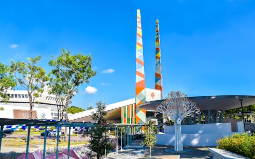 Visitors at Science Centre Singapore with colorful towers and modern architecture.