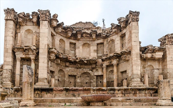 Roman ruins in Jerash, featuring ancient stone columns and arches, part of a day trip from Amman.