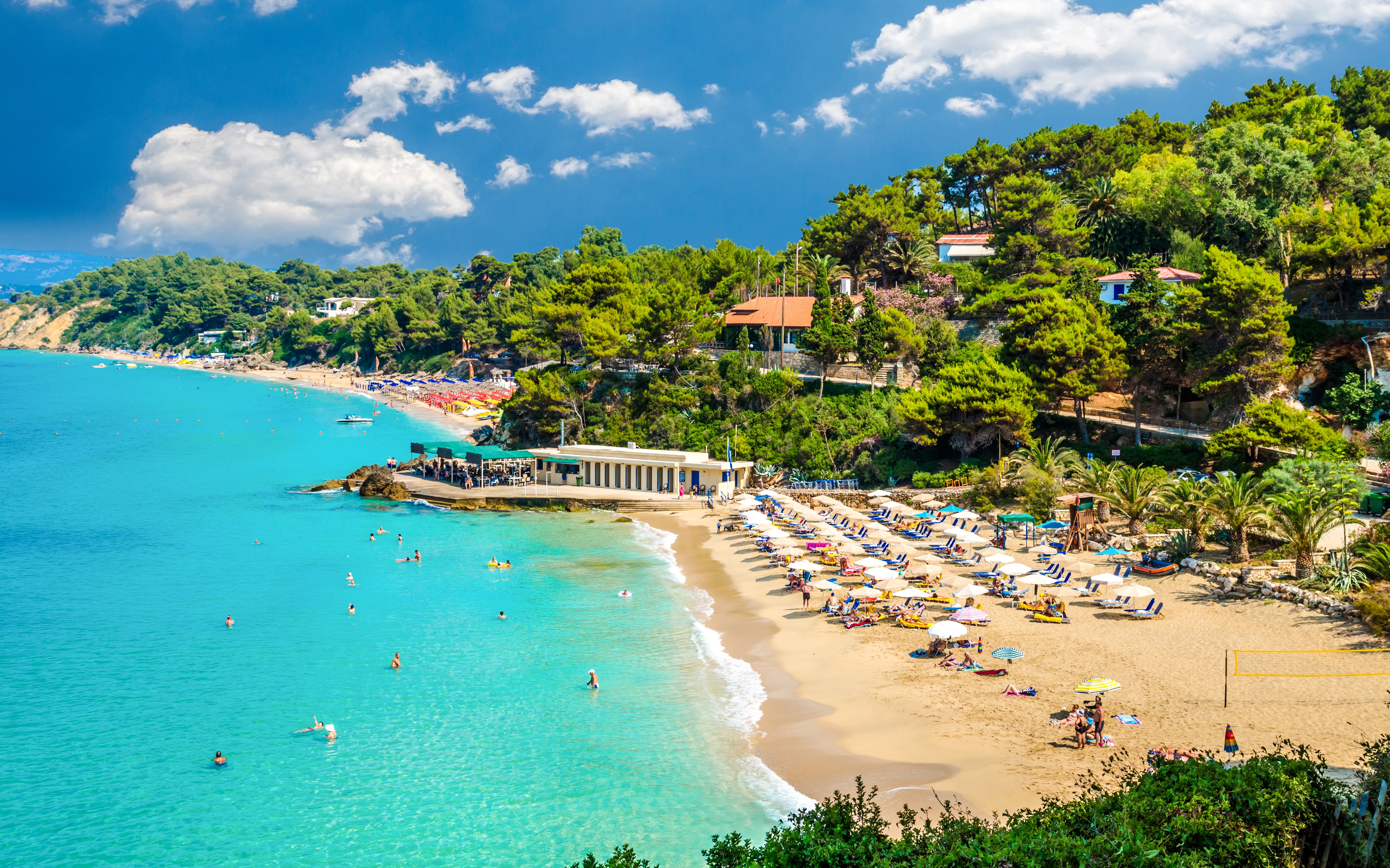 Makris Gialos beach with sunbathers and umbrellas, Argostoli, Kefalonia, Greece.