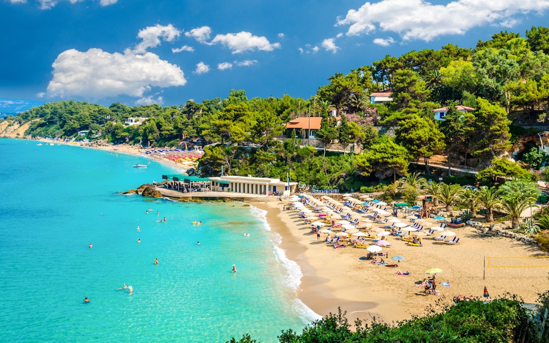 Makris Gialos beach with sunbathers and umbrellas, Argostoli, Kefalonia, Greece.