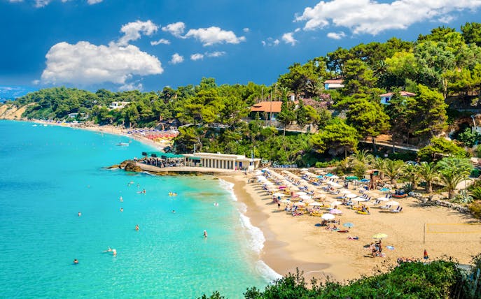Makris Gialos beach with sunbathers and umbrellas, Argostoli, Kefalonia, Greece.