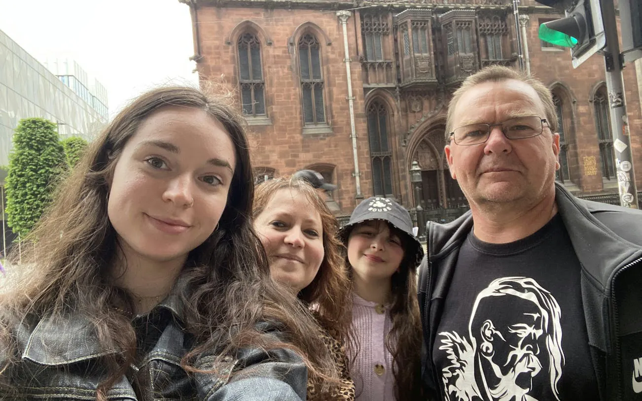 Group exploring Manchester city with historic architecture in the background.