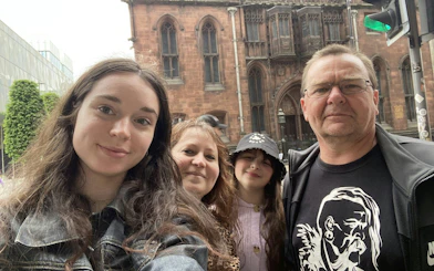 Group exploring Manchester city with historic architecture in the background.